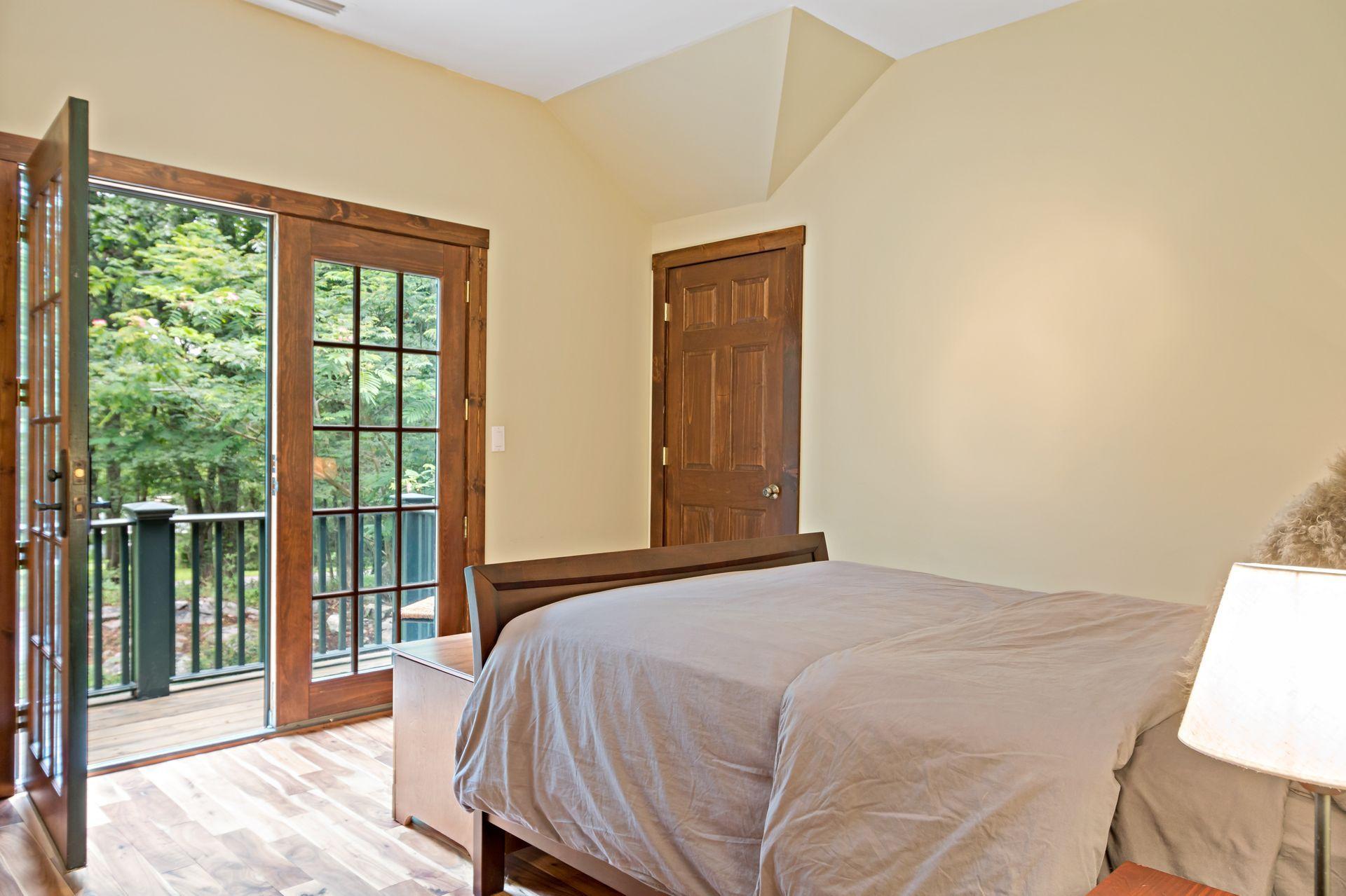 111 Old Kingdom Road Wilton, CT 06897 - Photo 52 of 57 a bedroom with a bed and a large window