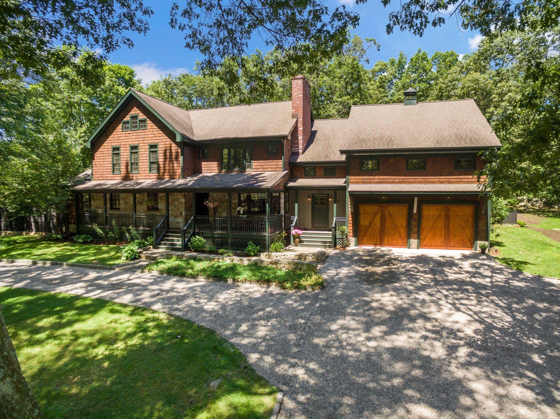 111 Old Kingdom Road Wilton, CT 06897 - Photo 56 of 57 a front view of a house with a yard and garage