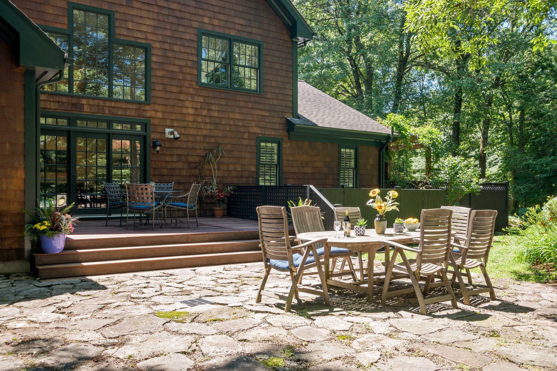 111 Old Kingdom Road Wilton, CT 06897 - Photo 6 of 57 a view of a patio with table and chairs and potted plants