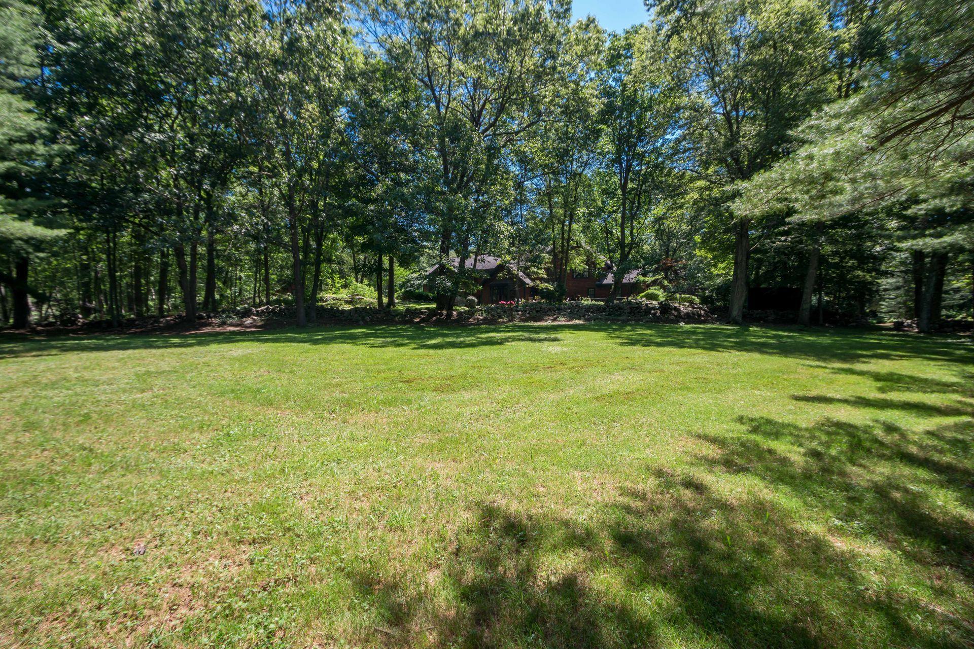 111 Old Kingdom Road Wilton, CT 06897 - Photo 7 of 57 a view of a grassy field with trees in the background