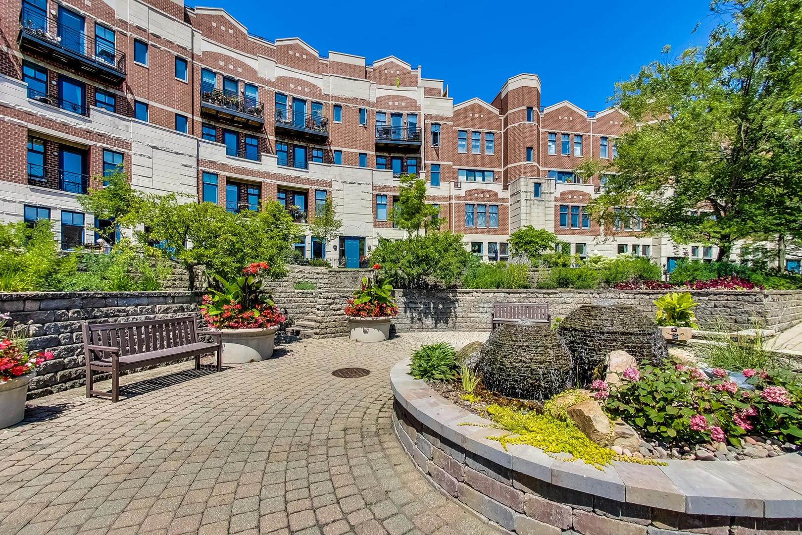 7742 North Sheridan Road, Unit 1L Chicago, IL 60626 - Photo 1 of 40 a view of a building with garden and sitting area