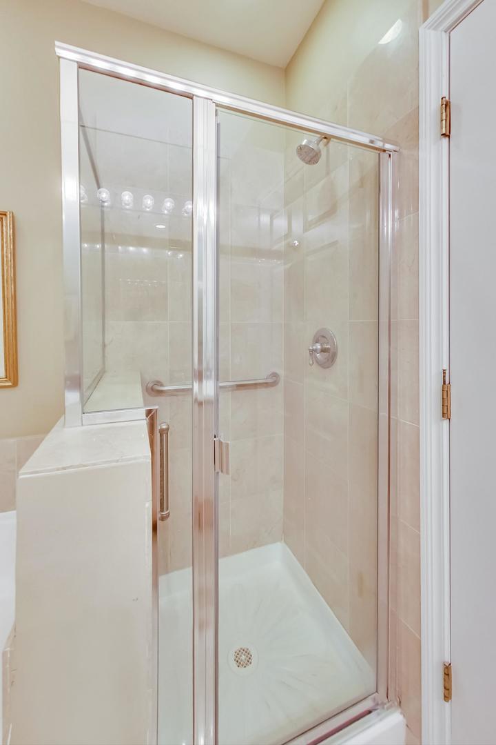 7742 North Sheridan Road, Unit 1L Chicago, IL 60626 - Photo 23 of 40 a bathroom with a glass shower door