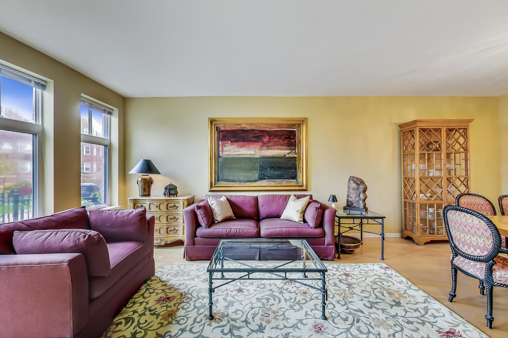 7742 North Sheridan Road, Unit 1L Chicago, IL 60626 - Photo 9 of 40 a living room with furniture a rug and a large window