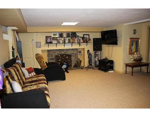 50 Mary Ellen Road Newton, MA 02468 - Photo 18 of 22 a living room with furniture a flat screen tv and a fireplace