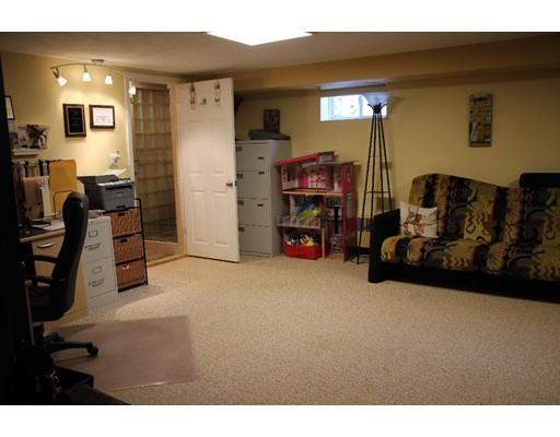 50 Mary Ellen Road Newton, MA 02468 - Photo 19 of 22 a living room with furniture a flat screen tv and gym equipment