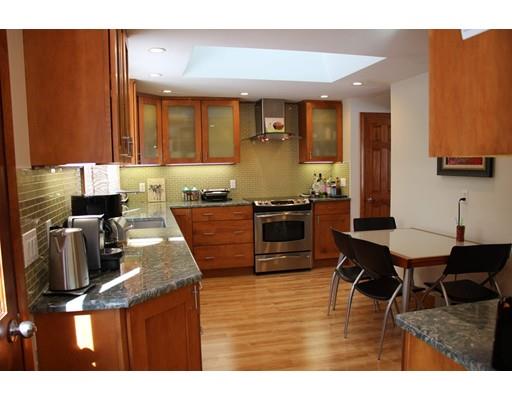 50 Mary Ellen Road Newton, MA 02468 - Photo 8 of 22 a kitchen with stainless steel appliances granite countertop a sink table and chairs