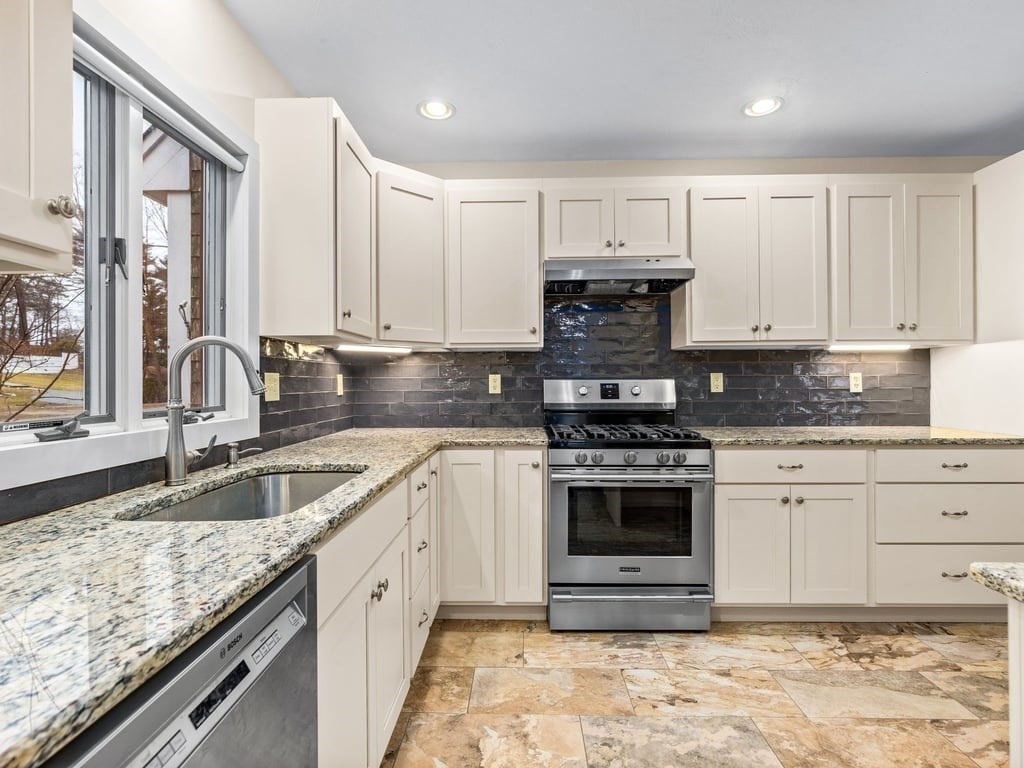 11 Wolf Road Bourne, MA 02532 - Photo 12 of 38 a kitchen with granite countertop a sink stainless steel appliances and cabinets