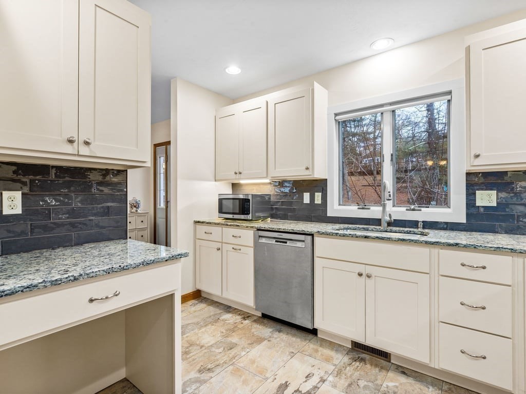 11 Wolf Road Bourne, MA 02532 - Photo 14 of 38 a kitchen with granite countertop white cabinets stainless steel appliances a sink and a window