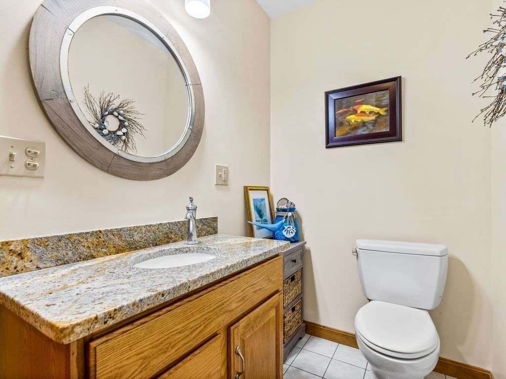 11 Wolf Road Bourne, MA 02532 - Photo 15 of 38 a bathroom with a granite countertop toilet sink and mirror
