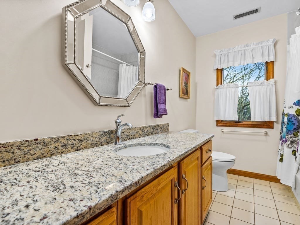 11 Wolf Road Bourne, MA 02532 - Photo 18 of 38 a bathroom with a granite countertop sink and a mirror
