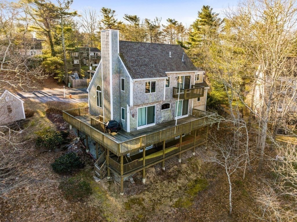 11 Wolf Road Bourne, MA 02532 - Photo 31 of 38 a aerial view of a house with a yard and large trees