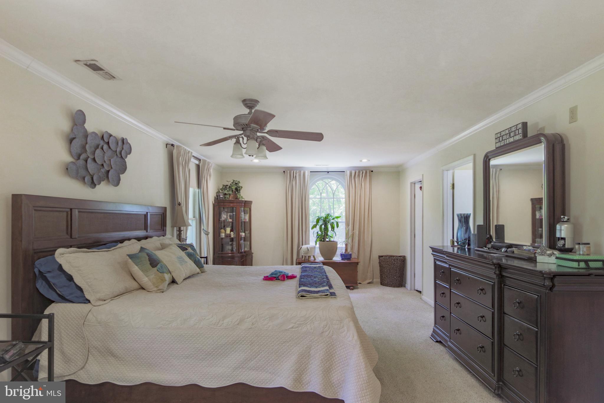 41 Wood Landing Road Fredericksburg, VA 22405 - Photo 9 of 79 a spacious bedroom with a bed and a chandelier