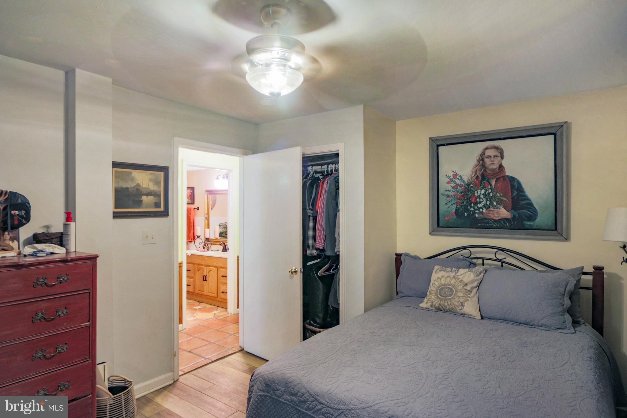 41 Wood Landing Road Fredericksburg, VA 22405 - Photo 19 of 79 a bedroom with a bed and a chandelier