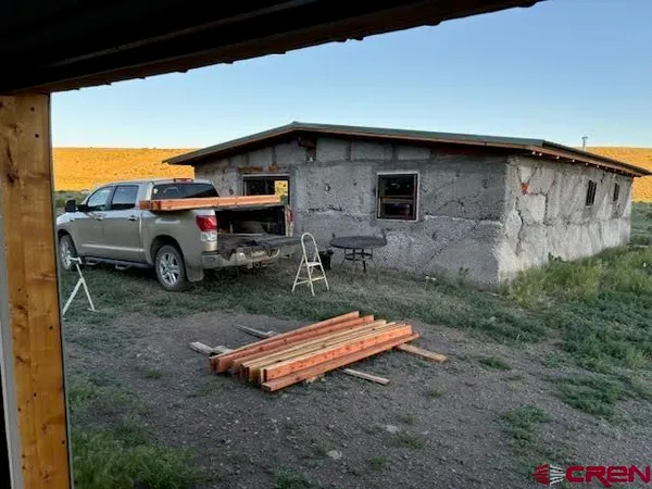 a backyard of a house with barbeque oven