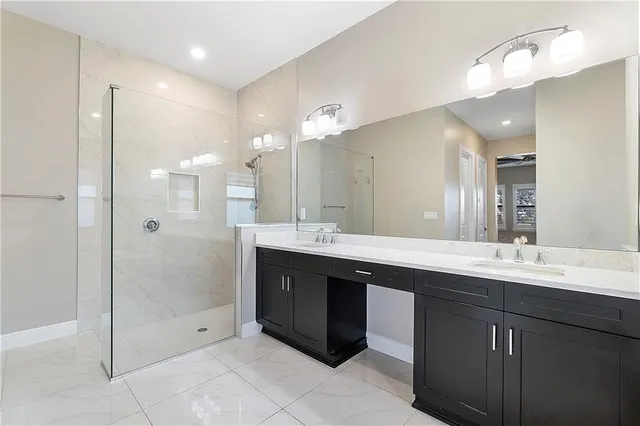 a bathroom with a toilet sink vanity and mirror