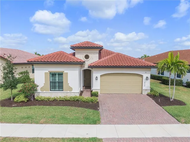 a front view of a house with a yard and garage