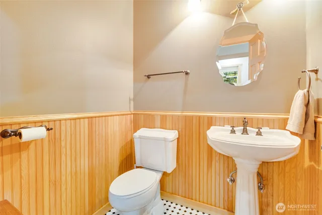 a bathroom with a sink mirror and toilet
