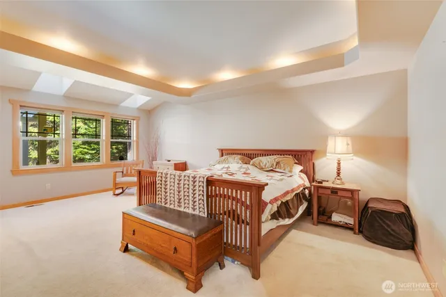 a spacious bedroom with a bed and a couch