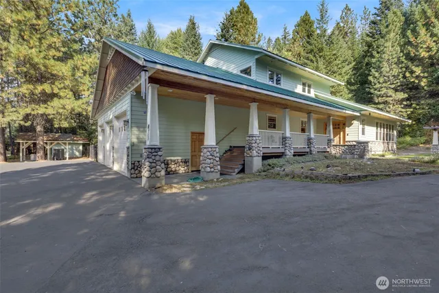 a front view of a house with yard and outdoor seating