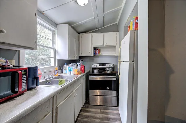 a view of a hallway with wooden floor and stairs