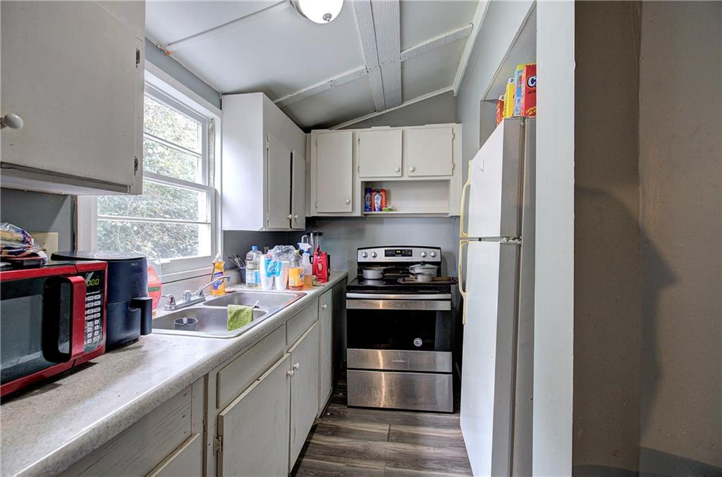 105 Mary Street Rome, GA 30161 - Photo 7 of 15 a kitchen with stainless steel appliances a sink a stove and a refrigerator