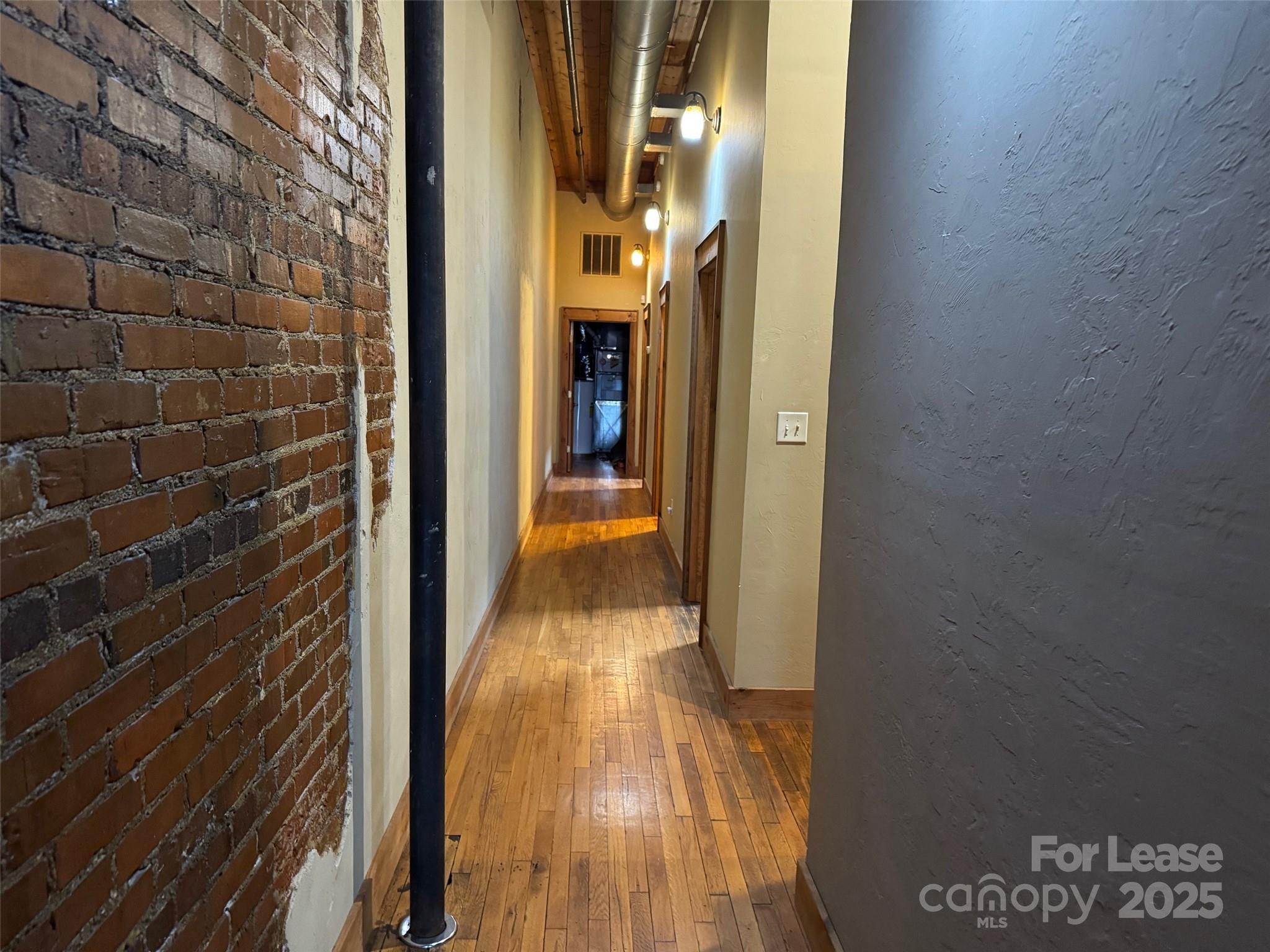 110 Church Street Northwest Lenoir, NC 28645 - Photo 8 of 11 a view of a hallway with wooden floor and a bathroom