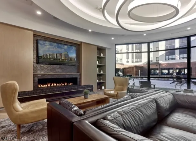 a living room with furniture and a floor to ceiling window
