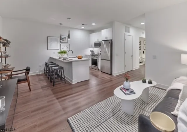 a open dining room with stainless steel appliances furniture or wooden floor