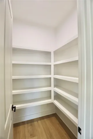 a large kitchen with stainless steel appliances granite countertop a large stove a sink dishwasher and a refrigerator with wooden floor