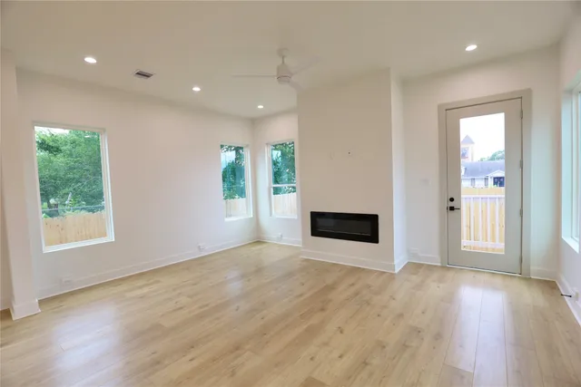 a kitchen with stainless steel appliances granite countertop a sink a stove and a refrigerator