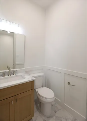 an empty room with windows and fireplace