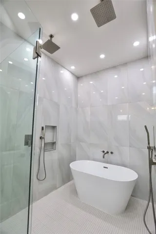 a bathroom with a granite countertop sink a mirror and a shower