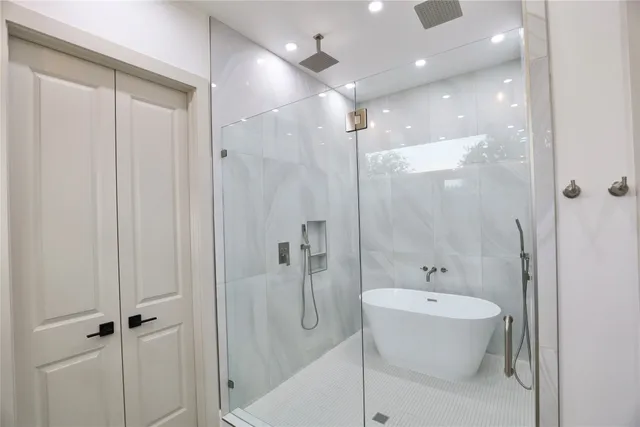 a bathroom with a bathtub and shower