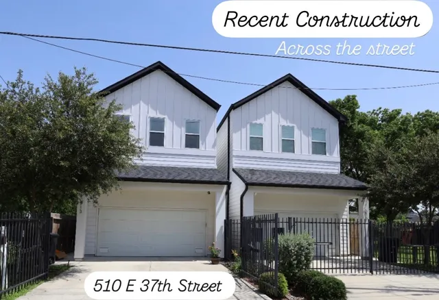 a view of a back yard with wooden fence