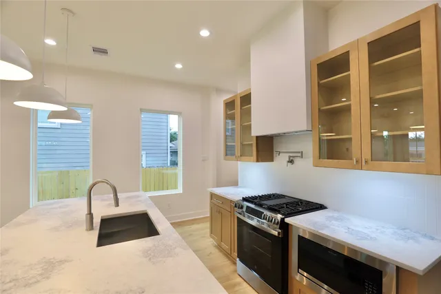 a kitchen with a stove and a kitchen island