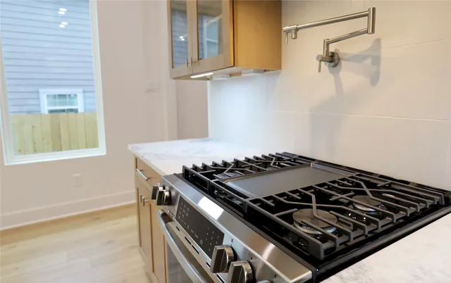 a stove top oven sitting inside of a kitchen