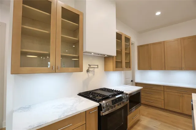 a kitchen with granite countertop a stove and a cabinets