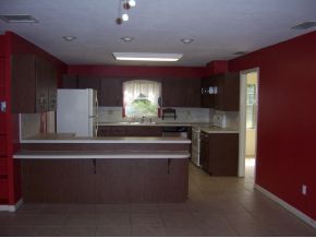 3880 Lakemont Road Melbourne, FL 32934 - Photo 5 of 8 a kitchen with counter top space cabinets and stainless steel appliances
