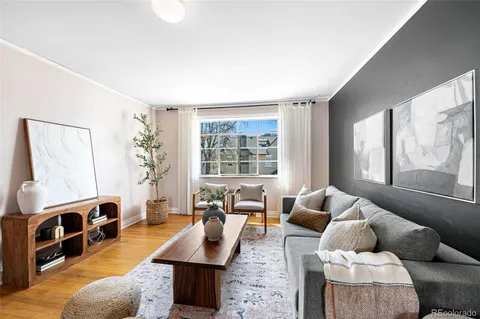 a living room with furniture fireplace and a large window