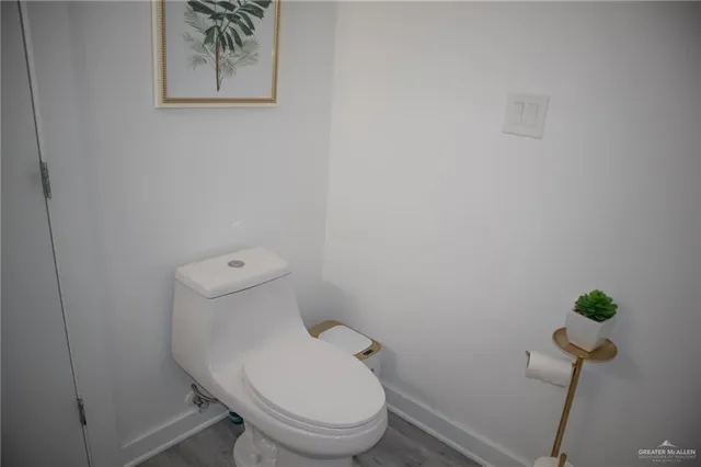 a white toilet sitting next to a shower