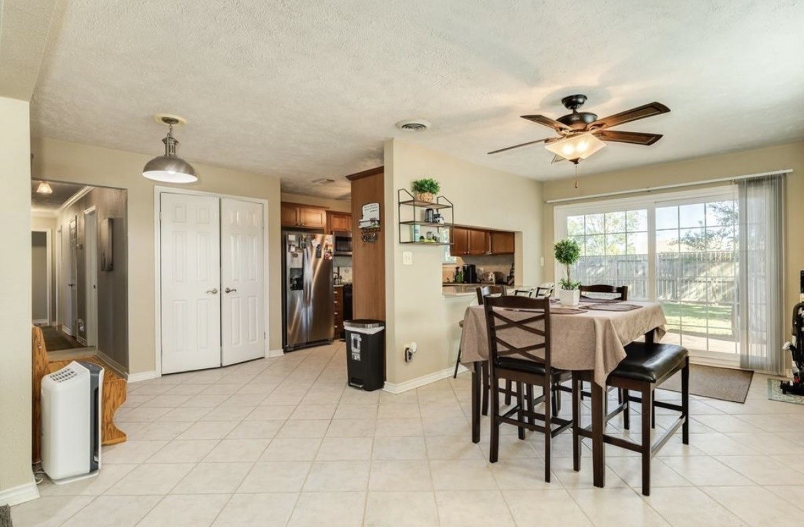 820 Perry Street Angleton, TX 77515 - Photo 14 of 26 a view of a dining room with furniture and a chandelier