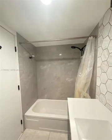 a bedroom with bed and window