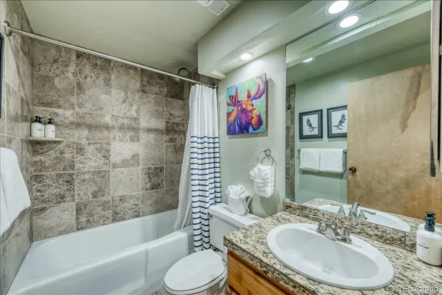 a bedroom with two beds and a large window