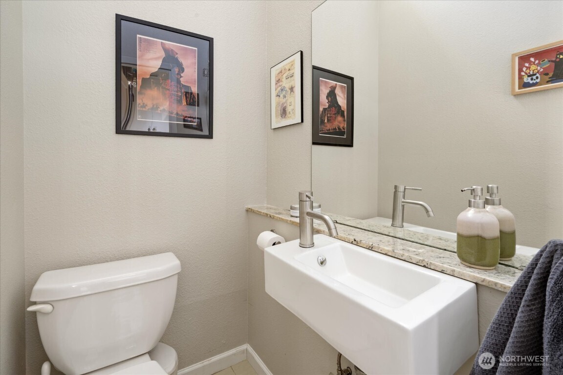 1724 26th Avenue Seattle, WA 98122 - Photo 16 of 28 a bathroom with a toilet a sink and mirror