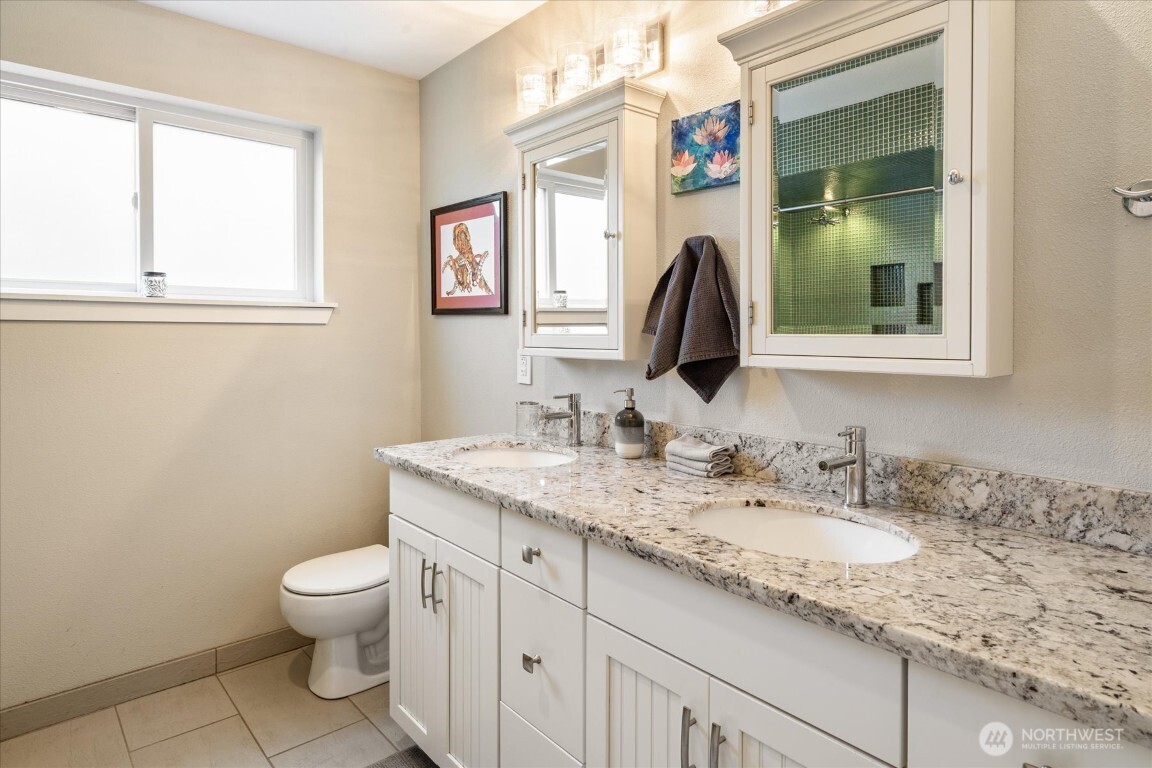 1724 26th Avenue Seattle, WA 98122 - Photo 21 of 28 a bathroom with a granite countertop toilet sink and mirror