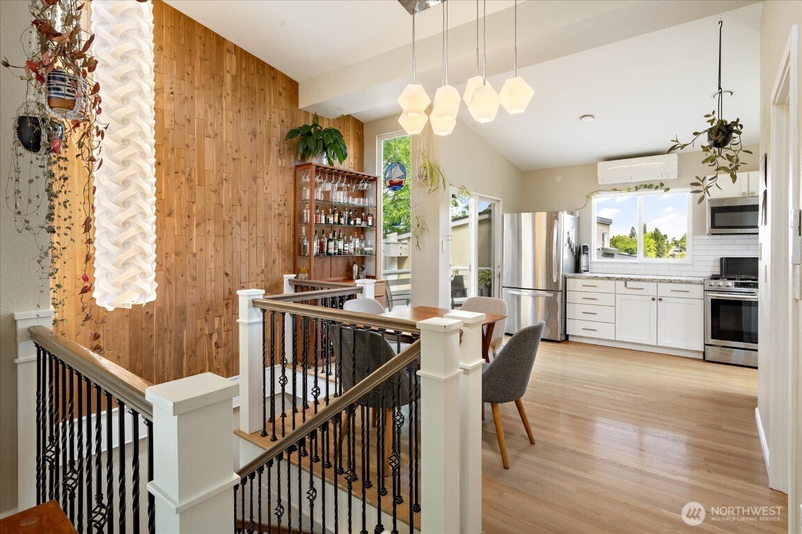 1724 26th Avenue Seattle, WA 98122 - Photo 9 of 28 a view of a dining room and furniture window wooden floor and a chandelier