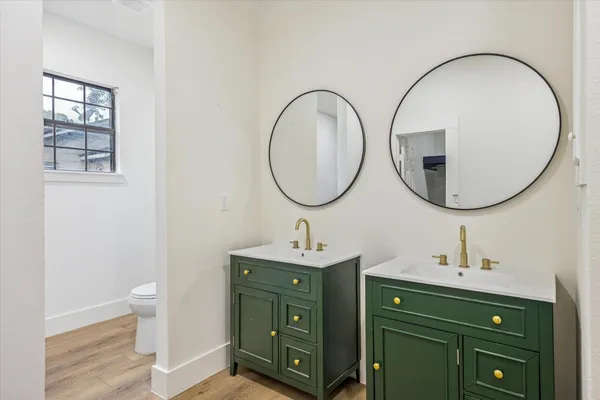 a bathroom with a double vanity sink and a mirror
