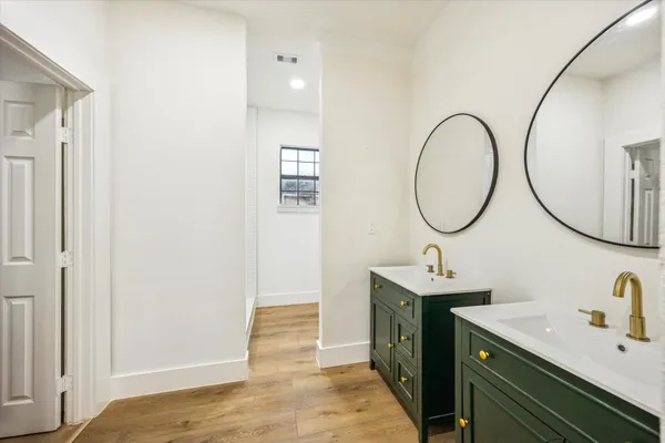 a bathroom with a sink double vanity and a mirror