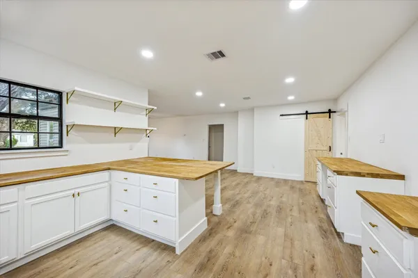a kitchen with granite countertop a stove and a wooden floors