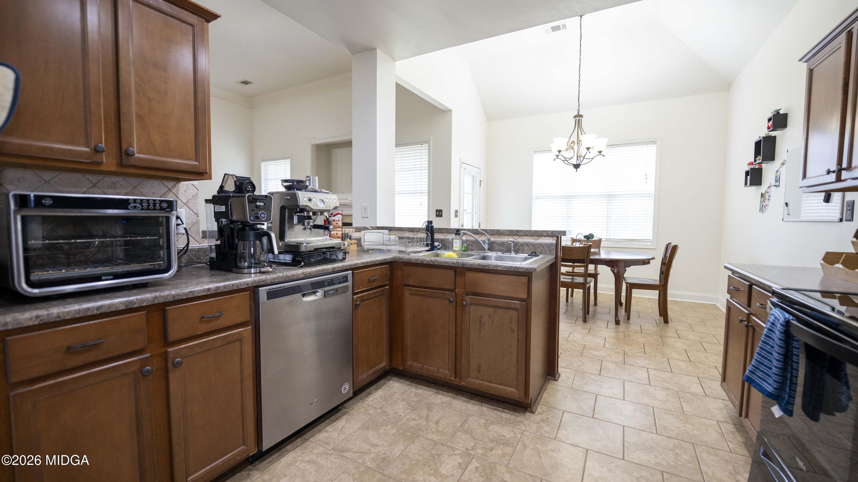 207 Broderick Circle Warner Robins, GA 31088 - Photo 14 of 33 a kitchen with stainless steel appliances granite countertop a stove a sink and a microwave